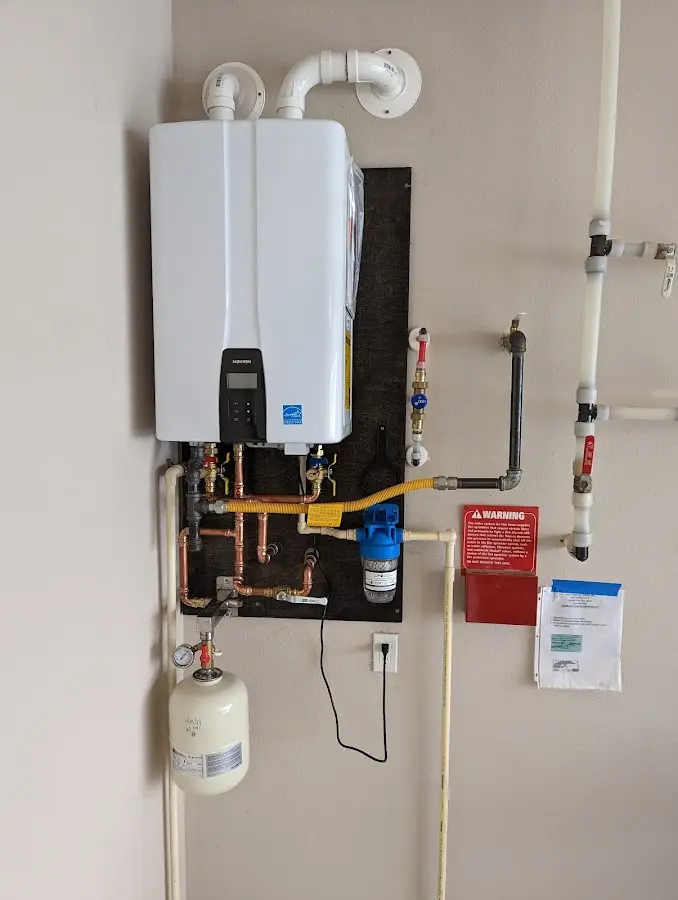 Professional plumber installing copper piping in a Uwchlan home